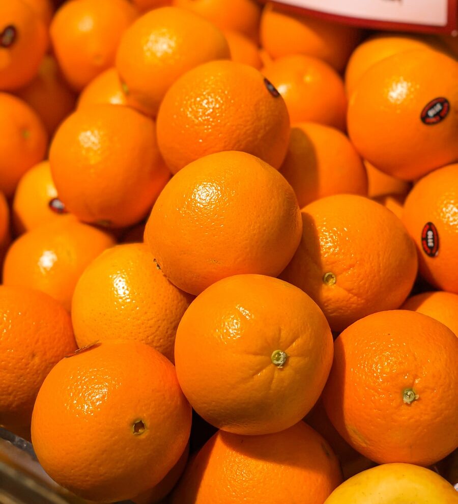 orange fruits on white ceramic plate