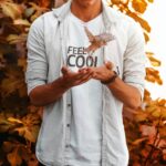 a man is holding a leaf in his hands